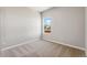 Well-lit bedroom with neutral walls and carpet flooring at 7318 Arkansas St, Frederick, CO 80530