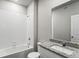 Clean bathroom with granite countertop, bathtub, and toilet at 7318 Arkansas St, Frederick, CO 80530