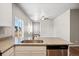 Modern kitchen with island, granite counters and stainless steel appliances at 7318 Arkansas St, Frederick, CO 80530