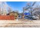 Ranch style home with yard and wooden fence at 354 S Quitman St, Denver, CO 80219