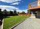 Large backyard with grassy area, gravel pathway and wooden fence at 1734 Foxfield Dr, Castle Rock, CO 80104