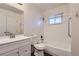 Updated bathroom with tub, shower, and white tile at 1922 S Oswego Way, Aurora, CO 80014