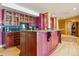 Curved bar with granite countertop and extensive cabinetry in the basement at 15958 Shadow Mountain Ranch Rd, Larkspur, CO 80118