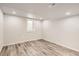 Finished basement room with wood-look floors and a window at 5265 Chandler Way, Denver, CO 80239