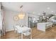 Open concept dining room with modern chandelier and seating for six at 2025 W 35Th Ave, Denver, CO 80211