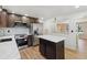 Eat-in kitchen with stainless steel appliances and an island at 8543 W Arizona Dr, Lakewood, CO 80232