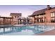 Luxury pool with cabanas and a view of the clubhouse at 492 Agoseris Way, Castle Rock, CO 80104