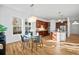 Open concept kitchen and dining area with hardwood floors and modern fixtures at 3356 Ulster St, Denver, CO 80238