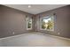 Bright bedroom with neutral walls, plush carpeting, and large windows offering scenic views at 22141 Chippewa Ln, Golden, CO 80401