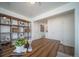 Home office features built-in shelving and a large desk at 45044 Sunflower Ln, Bennett, CO 80102