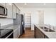 Modern kitchen with gray cabinets, granite counters, and walk-in pantry at 6525 13Th St, Frederick, CO 80530