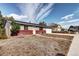 Front view of charming ranch home with brick and siding at 3265 Mather St, Brighton, CO 80601