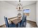 Spacious dining area with a rustic wooden table and blue chairs at 16475 Essex S Rd, Platteville, CO 80651