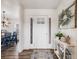 Bright entryway with hardwood floors and a view of the dining area at 16475 Essex S Rd, Platteville, CO 80651