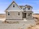 Two-story home with light gray siding and stone accents at 16475 Essex S Rd, Platteville, CO 80651