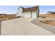Three-car garage and expansive driveway at 16475 Essex S Rd, Platteville, CO 80651