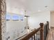 Upstairs hallway with hardwood floors and railing at 16475 Essex S Rd, Platteville, CO 80651