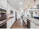 Modern kitchen with white cabinets, granite counters, and stainless steel appliances at 16475 Essex S Rd, Platteville, CO 80651