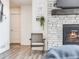 Cozy sitting area with fireplace and hardwood floors at 16475 Essex S Rd, Platteville, CO 80651