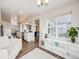 Open concept living room, kitchen, and dining area with hardwood floors at 16475 Essex S Rd, Platteville, CO 80651