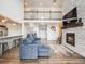 Two-story living room with a stone fireplace and hardwood floors at 16475 Essex S Rd, Platteville, CO 80651