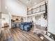 Open concept living area with hardwood floors and a fireplace at 16475 Essex S Rd, Platteville, CO 80651