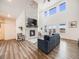 Spacious living room with a stone fireplace and large windows at 16475 Essex S Rd, Platteville, CO 80651