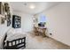 Functional home office with a desk, comfortable seating, and built-in shelving at 16475 Essex S Rd, Platteville, CO 80651