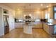 Modern kitchen with white cabinets, stainless steel appliances, and large island at 13563 E 106Th Pl, Commerce City, CO 80022