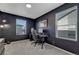 Stylish home office with dark accent wall, two windows, and desk at 6541 N Dunkirk St, Denver, CO 80249