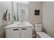 Modern powder room with white vanity and updated fixtures at 756 Dreamcatcher Ln, Evergreen, CO 80439