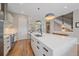 Modern kitchen with white cabinets, large island, and stainless steel appliances at 756 Dreamcatcher Ln, Evergreen, CO 80439