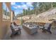 Outdoor patio with fire pit and seating area, perfect for entertaining at 756 Dreamcatcher Ln, Evergreen, CO 80439