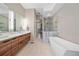 Elegant bathroom with double vanity, soaking tub, and walk-in shower at 756 Dreamcatcher Ln, Evergreen, CO 80439