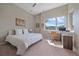 Bright bedroom with a king-size bed, workspace, and mountain views at 756 Dreamcatcher Ln, Evergreen, CO 80439