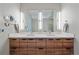 Modern bathroom with double vanity and sleek wood cabinets at 756 Dreamcatcher Ln, Evergreen, CO 80439