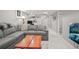 Spacious finished basement with gray sectional sofa and a live edge coffee table at 507 S Emerson St, Denver, CO 80209