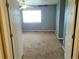 Bright bedroom with carpet flooring and two entry doors at 24728 E Arizona Cir, Aurora, CO 80018