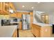 Kitchen with stainless steel appliances, oak cabinets, and a center island at 1214 S Akron Way, Denver, CO 80247