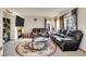 Cozy living room with a fireplace, leather furniture, and a patterned rug at 1214 S Akron Way, Denver, CO 80247