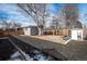 Spacious backyard with garden beds, playset, and storage shed at 1654 S Perry St, Denver, CO 80219