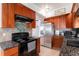 Kitchen with stainless steel appliances and wood cabinets at 1654 S Perry St, Denver, CO 80219