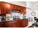 Kitchen with granite countertops and wood cabinets at 1654 S Perry St, Denver, CO 80219
