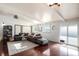 Living room with hardwood floors and large sectional sofa at 1654 S Perry St, Denver, CO 80219