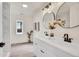 Modern bathroom with double vanity, marble tile, and spacious layout at 14405 County Road 12, Fort Lupton, CO 80621