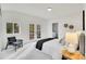 Spacious bedroom with a plush bed and private balcony access at 14405 County Road 12, Fort Lupton, CO 80621