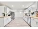 Modern kitchen with white cabinets and butcher block counters at 14405 County Road 12, Fort Lupton, CO 80621