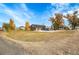 Two-story home with a large yard and mature trees at 14405 County Road 12, Fort Lupton, CO 80621