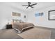 Spacious main bedroom with plush carpet, large windows, and ceiling fan at 3939 S Huron St, Englewood, CO 80110