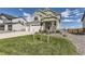 Two-story house with green and white siding, attached garage, and landscaped front yard at 39286 Hart Cir, Elizabeth, CO 80107